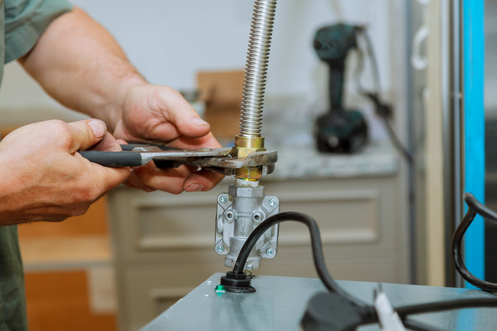 Licensed technician following gas line installation safety tips during residential gas line work