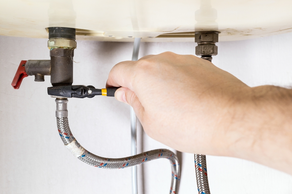 Professional plumber inspecting a residential plumbing issue before it worsens