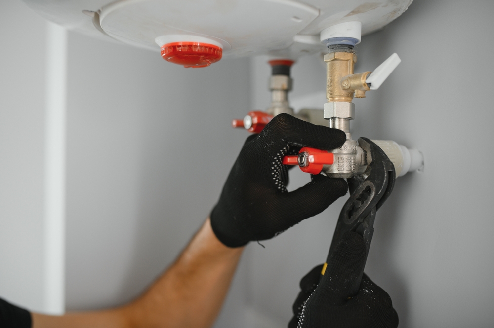 Plumber inspecting a Santa Rosa water heater making knocking and popping noises